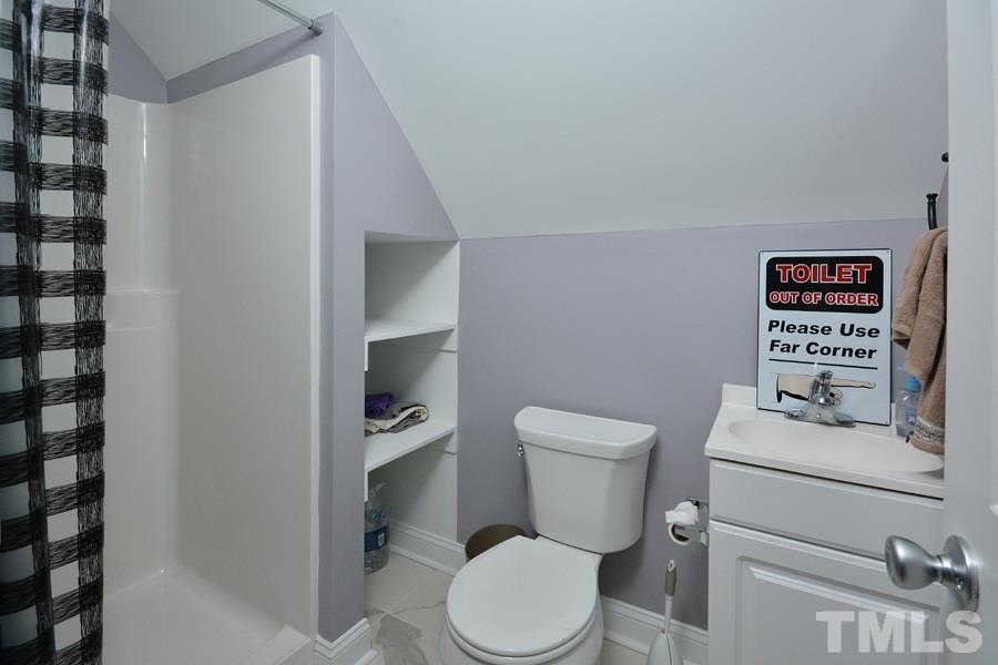 41 South Old Lantern Road Timberlake, NC 27583 - Photo 23 of 25 a white toilet sitting next to a bathroom sink