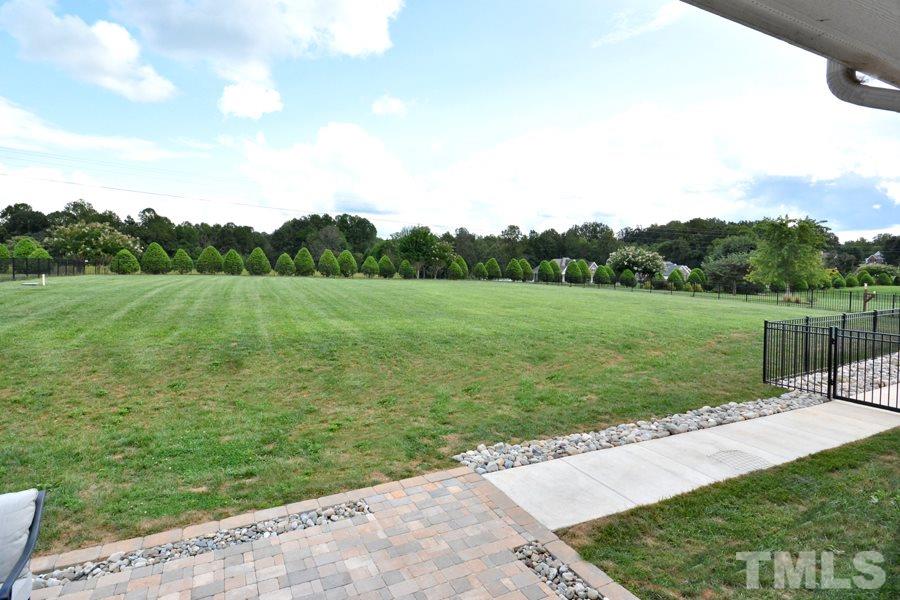 41 South Old Lantern Road Timberlake, NC 27583 - Photo 7 of 25 a view of a grassy field with trees in the background