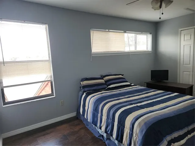 a bedroom with two beds and a window