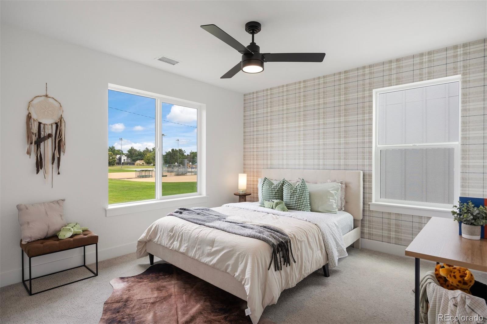 4000 Upham Street Wheat Ridge, CO 80033 - Photo 37 of 50 a bedroom with a bed a couch and a window