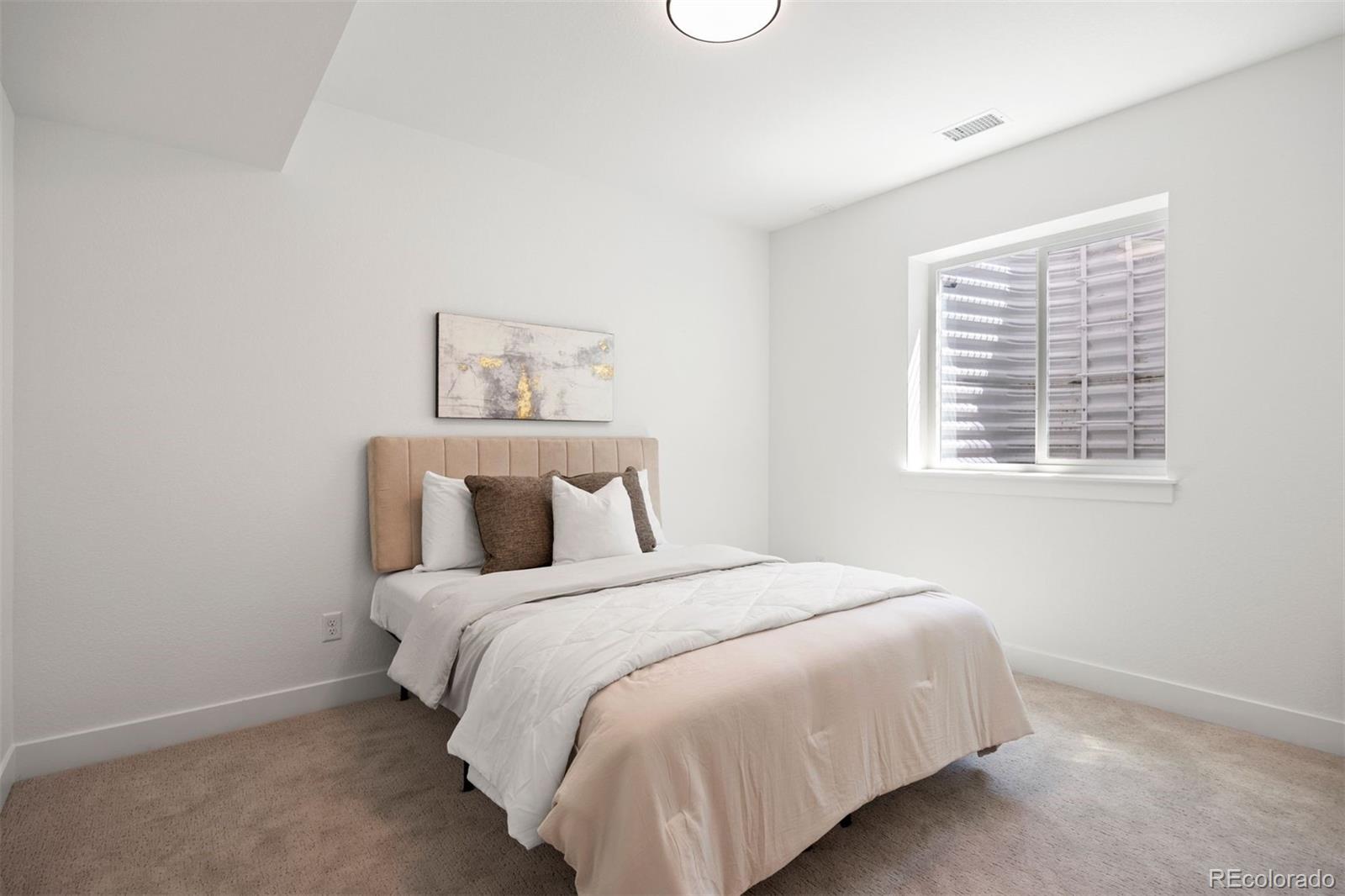 4000 Upham Street Wheat Ridge, CO 80033 - Photo 42 of 50 a large bed sitting in a bedroom next to a window