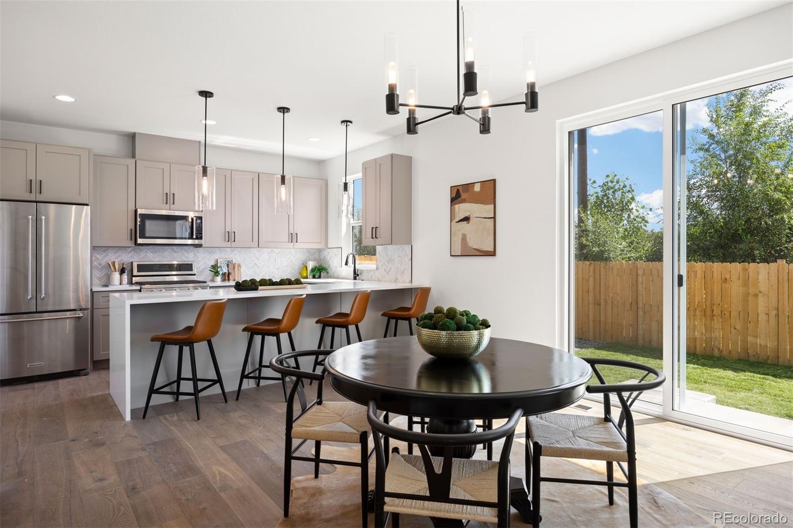 4000 Upham Street Wheat Ridge, CO 80033 - Photo 6 of 50 a kitchen with a dining table chairs and refrigerator