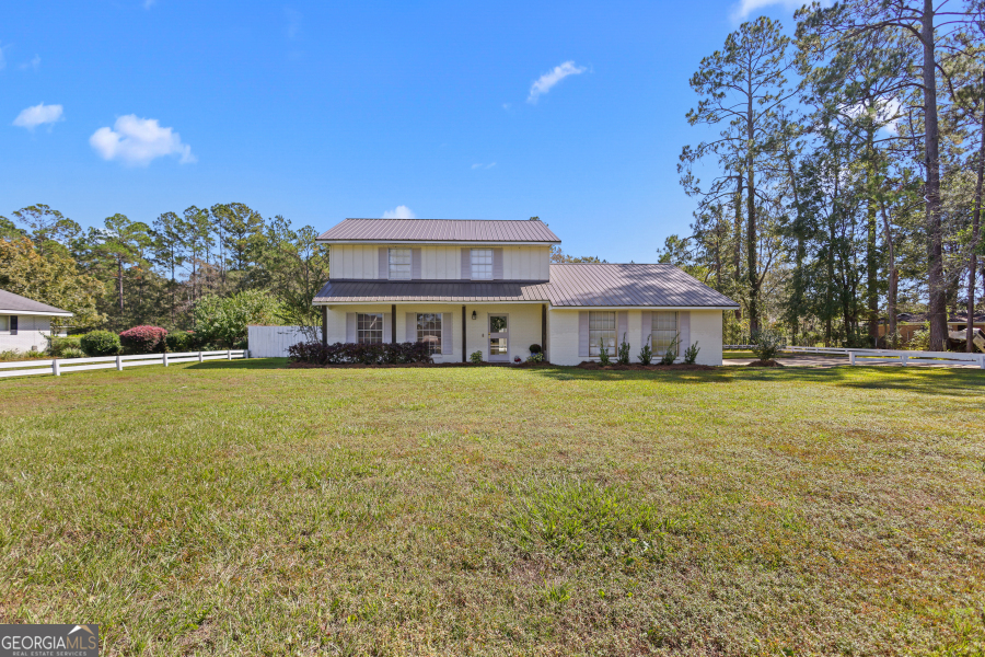 168 Pierce Street Jesup, GA 31545 - Photo 1 of 30 a front view of a building with swimming pool
