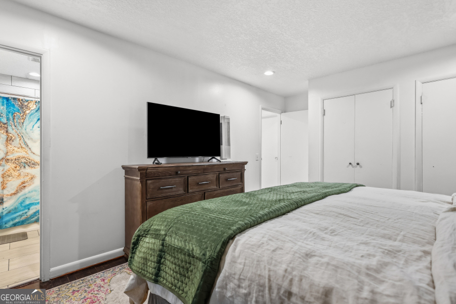 168 Pierce Street Jesup, GA 31545 - Photo 17 of 30 a bedroom with a bed and a flat screen tv