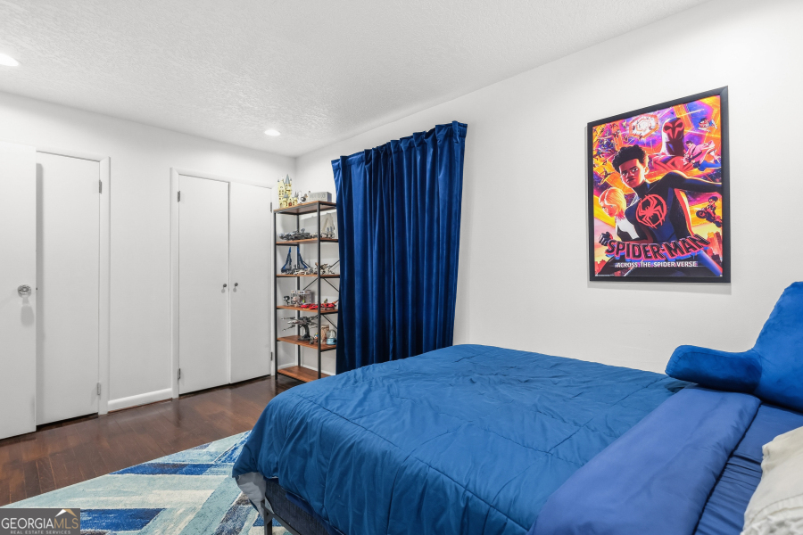 168 Pierce Street Jesup, GA 31545 - Photo 21 of 30 a bedroom with a bed and a bookshelf