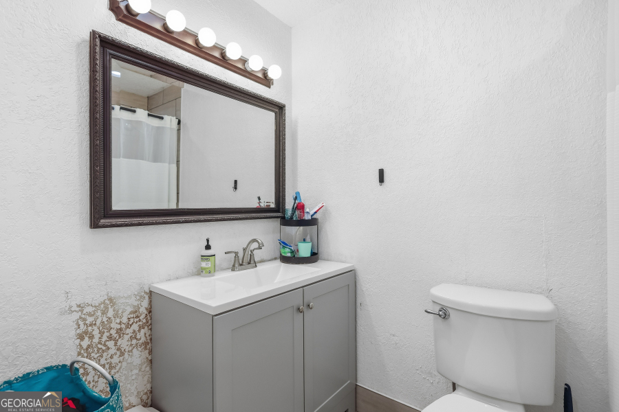 168 Pierce Street Jesup, GA 31545 - Photo 24 of 30 a bathroom with a sink vanity and a toilet
