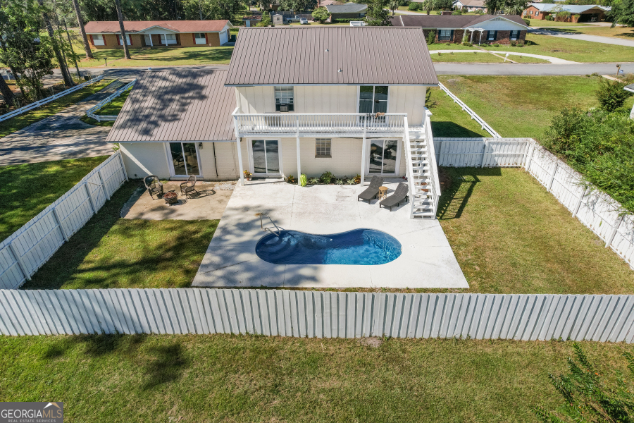 168 Pierce Street Jesup, GA 31545 - Photo 25 of 30 a view of a house with backyard and swimming pool