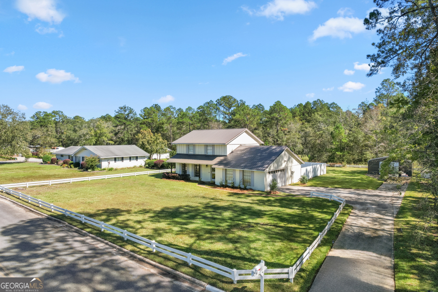 168 Pierce Street Jesup, GA 31545 - Photo 3 of 30 a front view of a house with garden