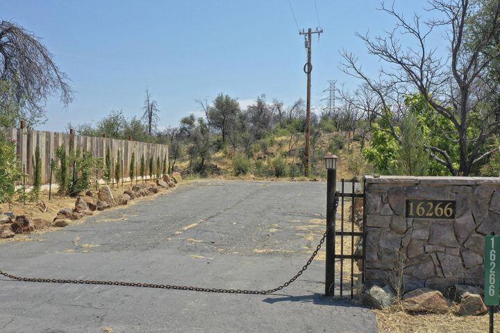 a view of a street with wooden fence