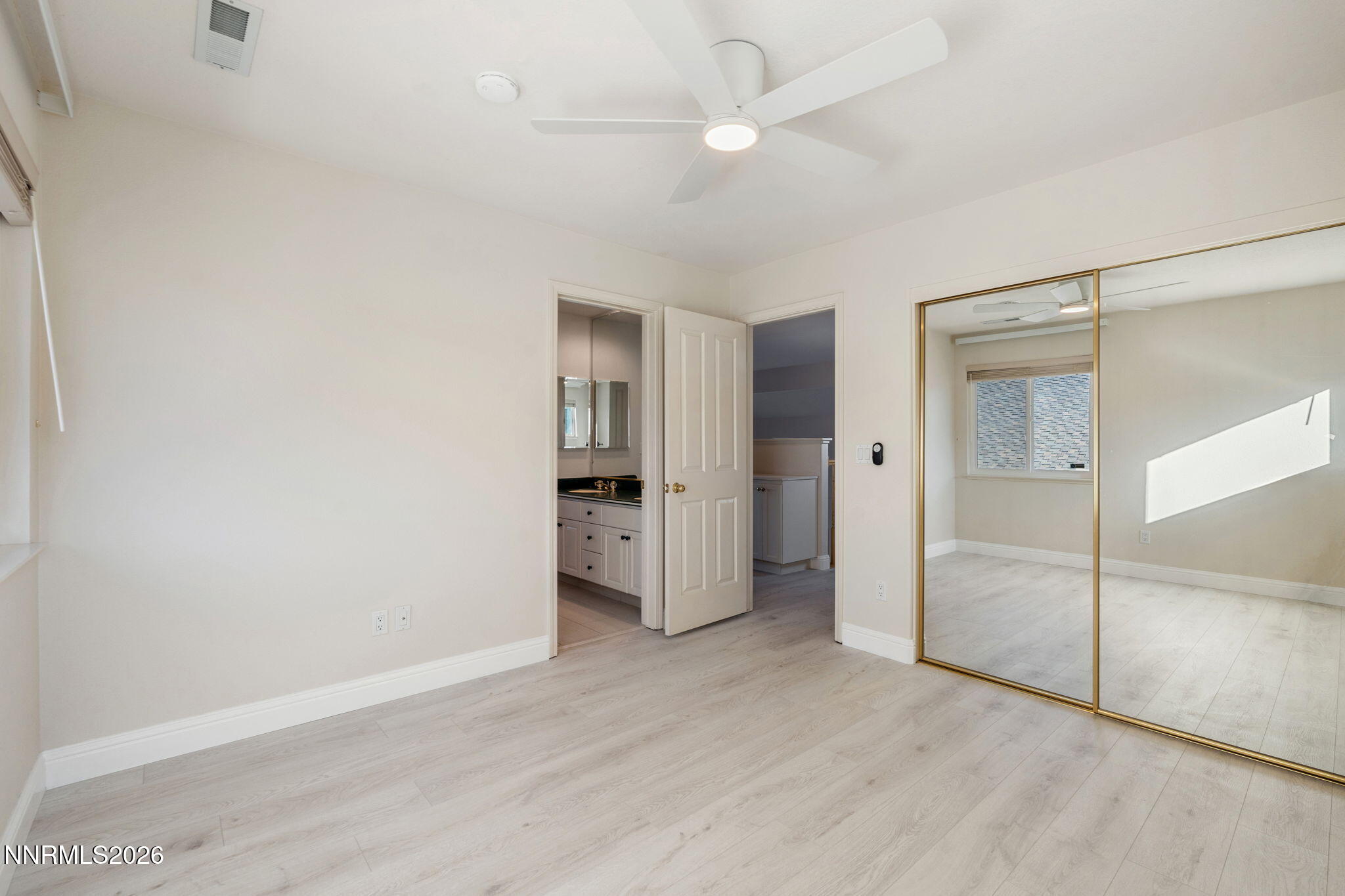 6186 Squires Lane Reno, NV 89519 - Photo 34 of 57 an empty room with closet and a ceiling fan