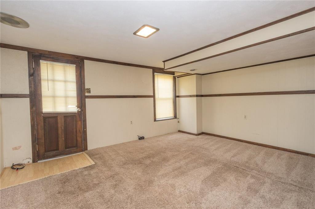 1701 Beaver Road Ambridge, PA 15003 - Photo 14 of 16 The lower level Family Room offers neutral wall and flooring tones with accented trim. With easy access to the back yard, this is sure to be a favored gathering place!