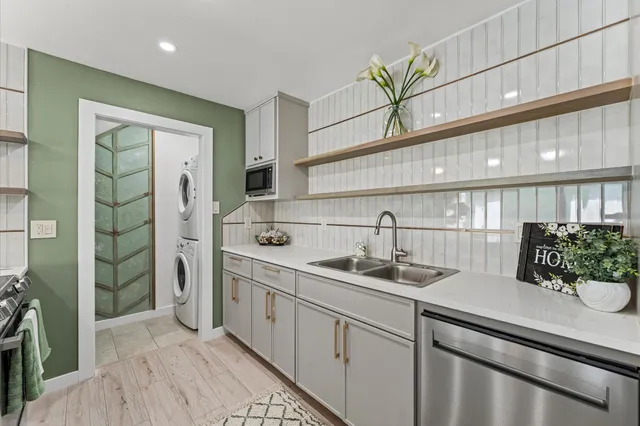 a kitchen that has a lot of windows and sink