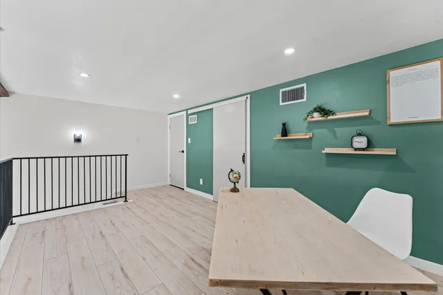 a workspace with furniture window and wooden floor