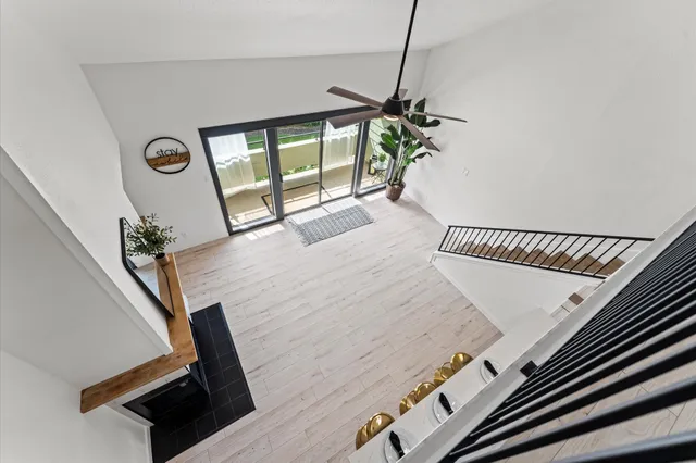 a view of a livingroom with furniture wooden floor and window