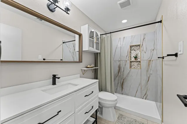 a bedroom with furniture and a window