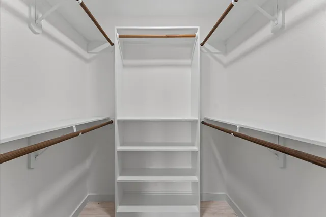 a bathroom with a sink a mirror a toilet and shower