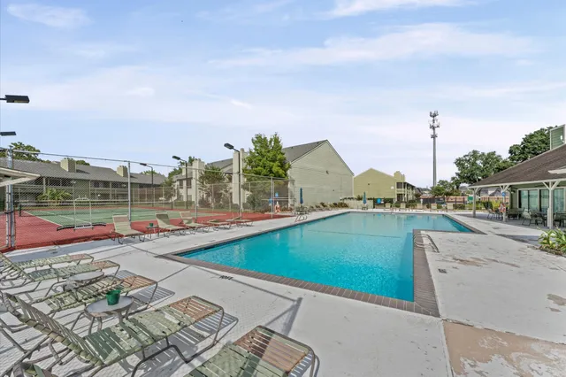 a view of a swimming pool with a lounge chairs