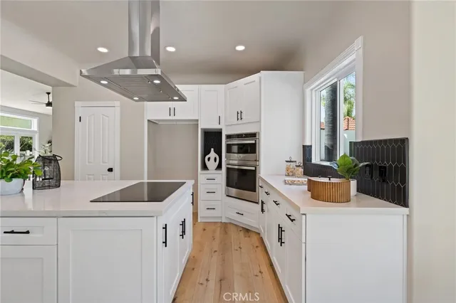 a dining room with furniture a chandelier and wooden floor