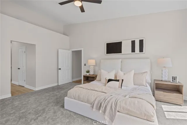 an empty room with closet and a ceiling fan