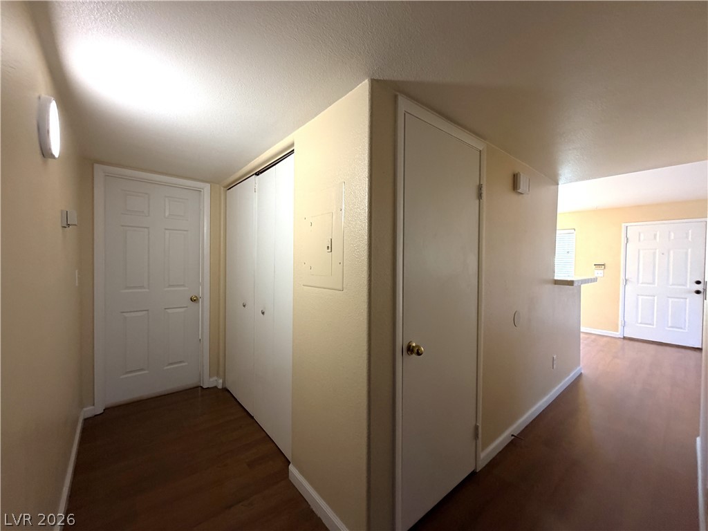 4955 South Lindell Road, Unit 203 Las Vegas, NV 89118 - Photo 23 of 31 A well-lit entry hallway with hardwood flooring leads into the living space.