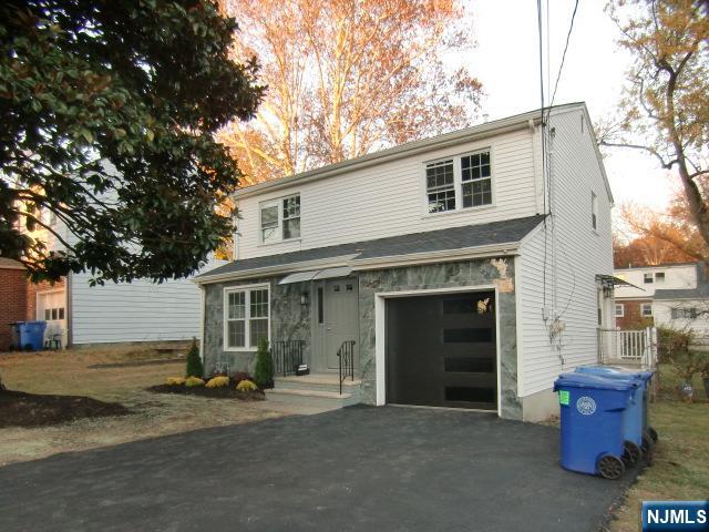 a view of a house with a yard and garage