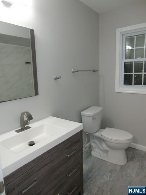 291 Liberty Road Englewood, NJ 07631 - Photo 33 of 49 a bathroom with a sink toilet and mirror