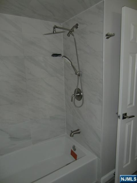 291 Liberty Road Englewood, NJ 07631 - Photo 34 of 49 a bath tub sitting next to a white sink and a shower