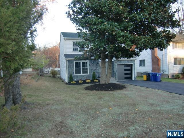 291 Liberty Road Englewood, NJ 07631 - Photo 4 of 49 a front view of a house with a yard and garage