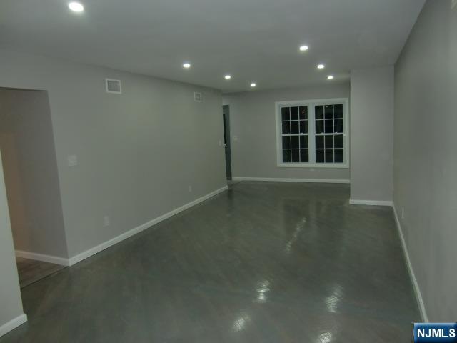 291 Liberty Road Englewood, NJ 07631 - Photo 7 of 49 an empty room with wooden floor and windows