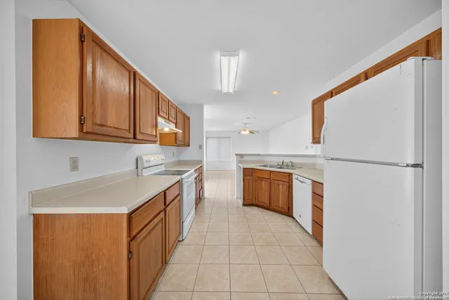 a kitchen with stainless steel appliances granite countertop a refrigerator a stove a sink and a microwave