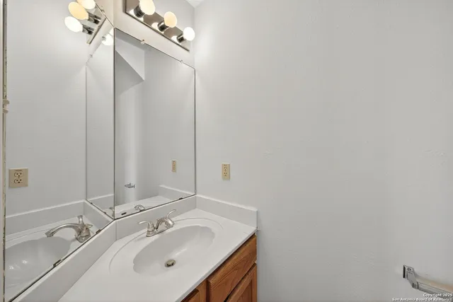 a bathroom with a sink and mirror