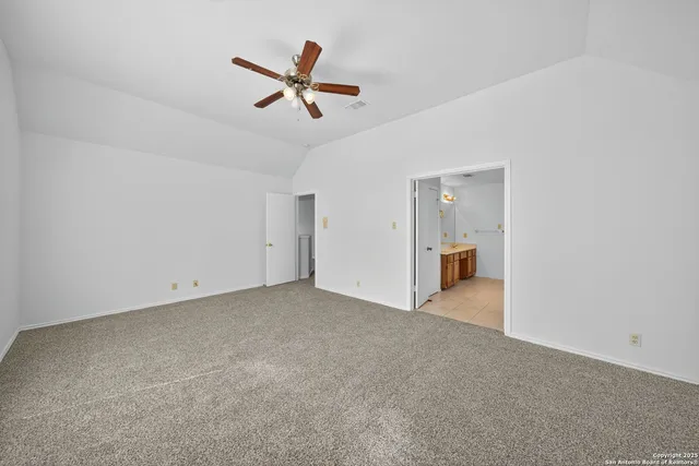 a view of a livingroom with a ceiling fan and window