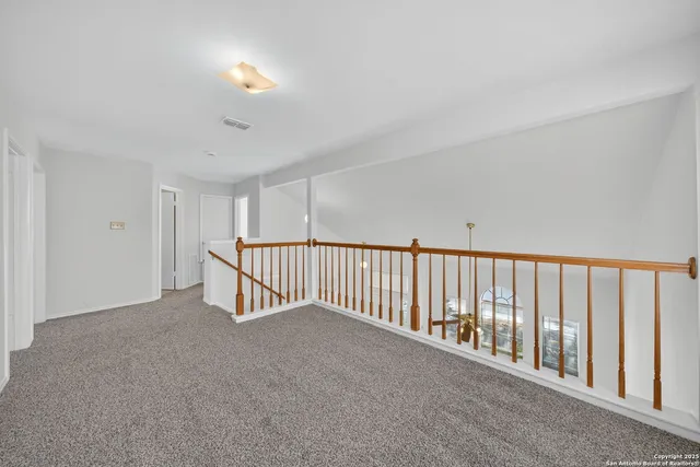 a view of a room with wooden floor and staircase