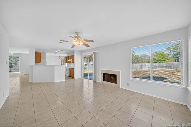a view of empty room with wooden floor and fireplace