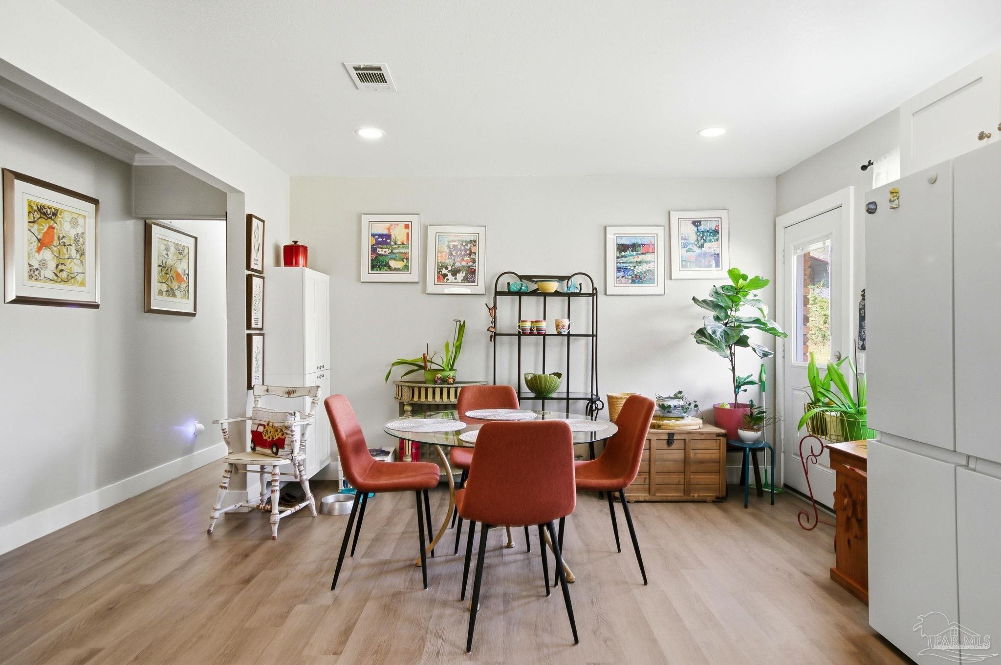 148 San Carlos Road Cantonment, FL 32533 - Photo 16 of 38 a dining room with furniture and wooden floor