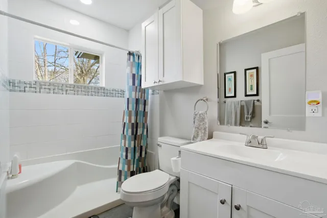 a bathroom with a sink toilet and vanity