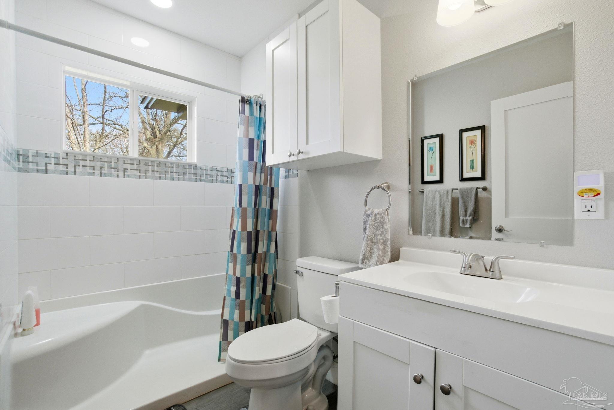 148 San Carlos Road Cantonment, FL 32533 - Photo 18 of 38 a bathroom with a sink toilet and vanity