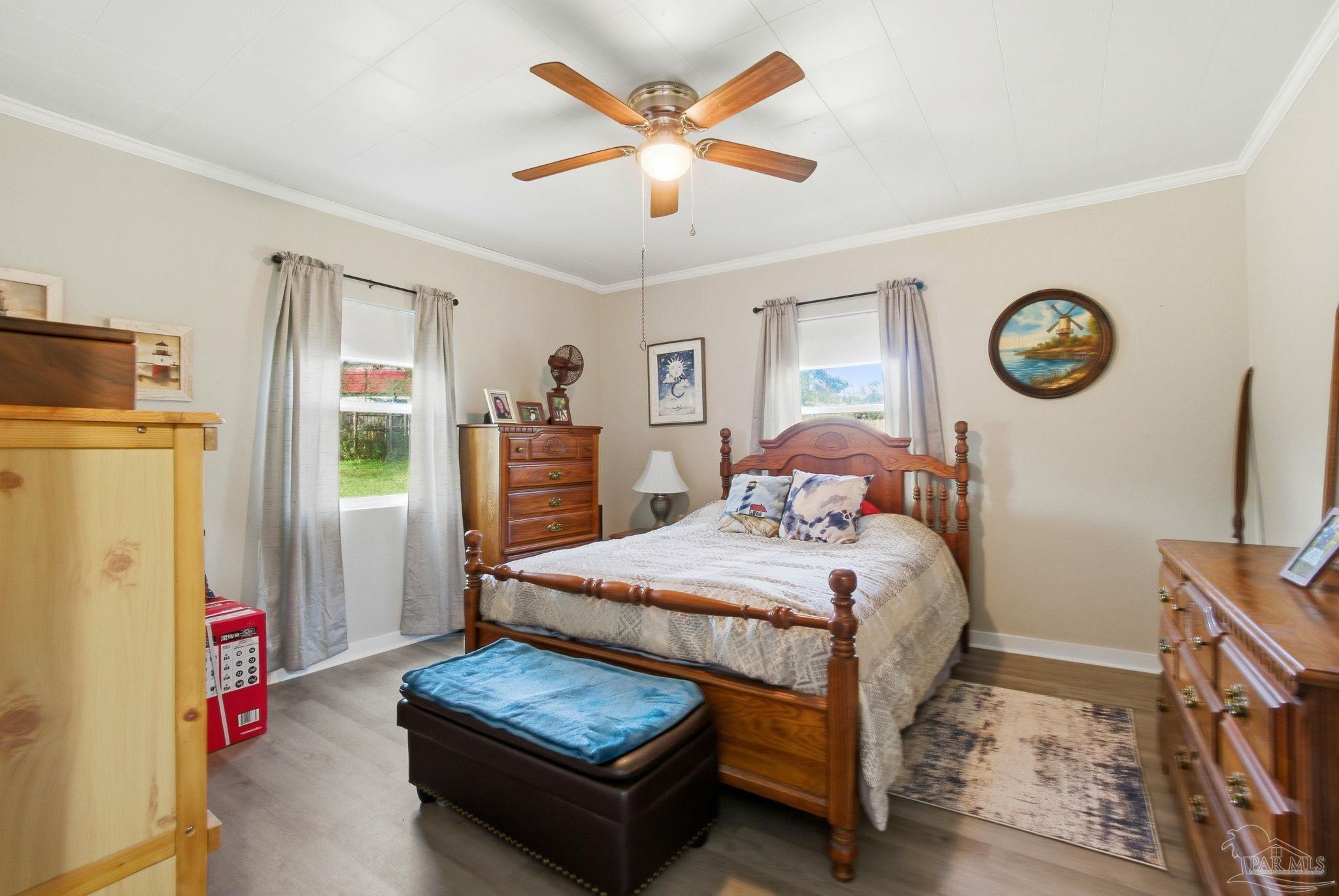 148 San Carlos Road Cantonment, FL 32533 - Photo 19 of 38 a bedroom with bed and a chandelier