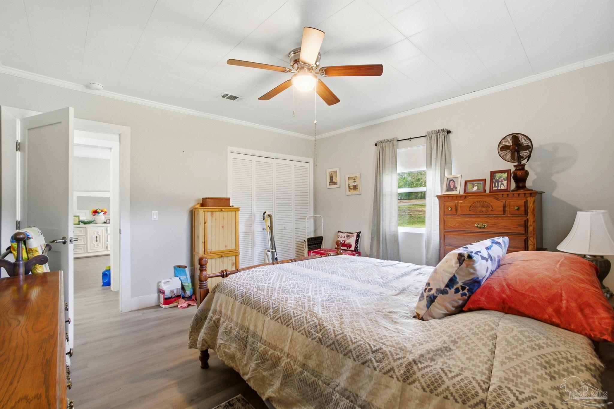 148 San Carlos Road Cantonment, FL 32533 - Photo 20 of 38 a bedroom with a bed and wooden floor