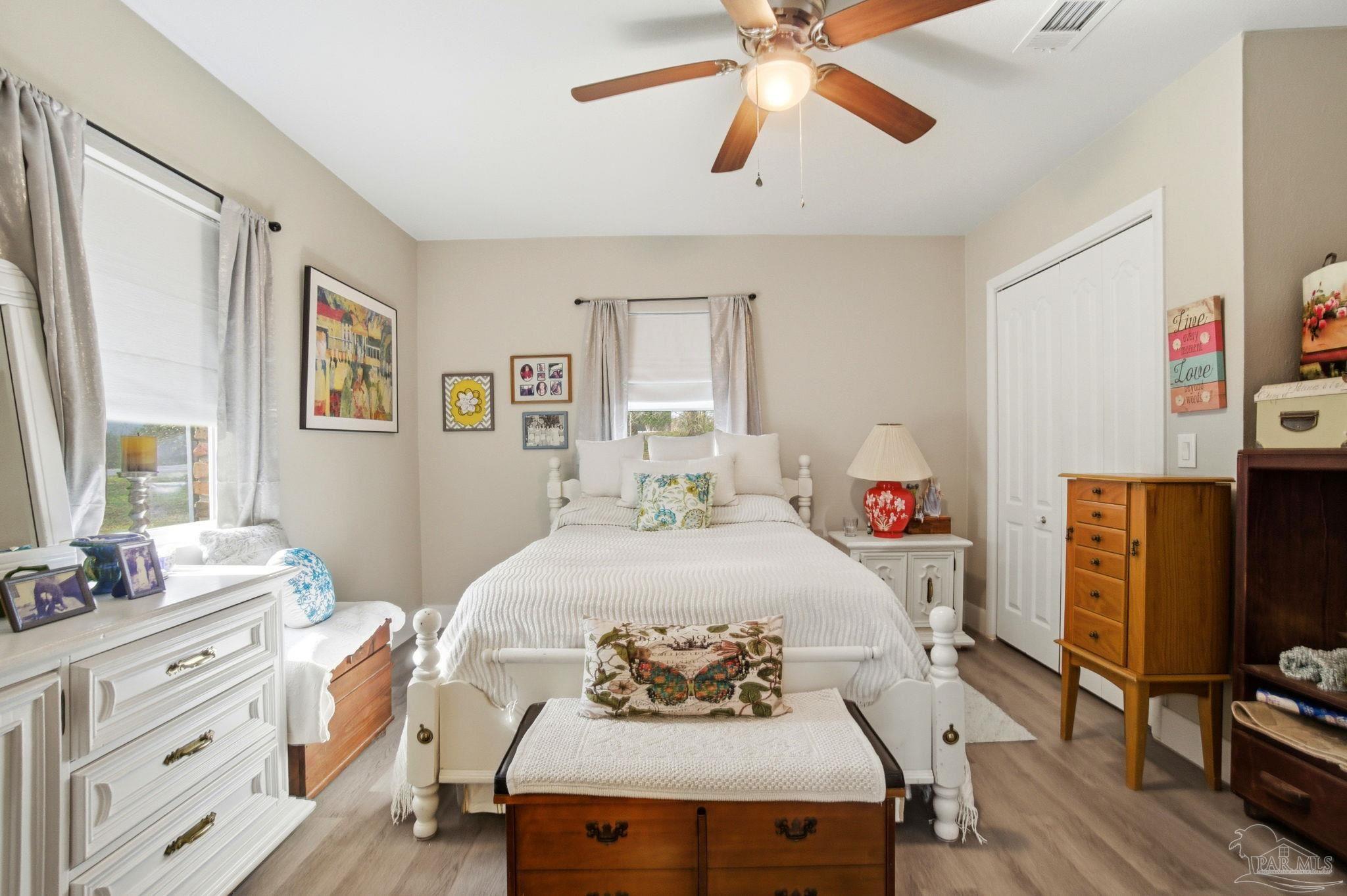 148 San Carlos Road Cantonment, FL 32533 - Photo 22 of 38 a bedroom with a bed and wooden floor