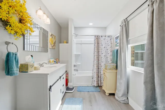 a bathroom with a sink a mirror and a shower