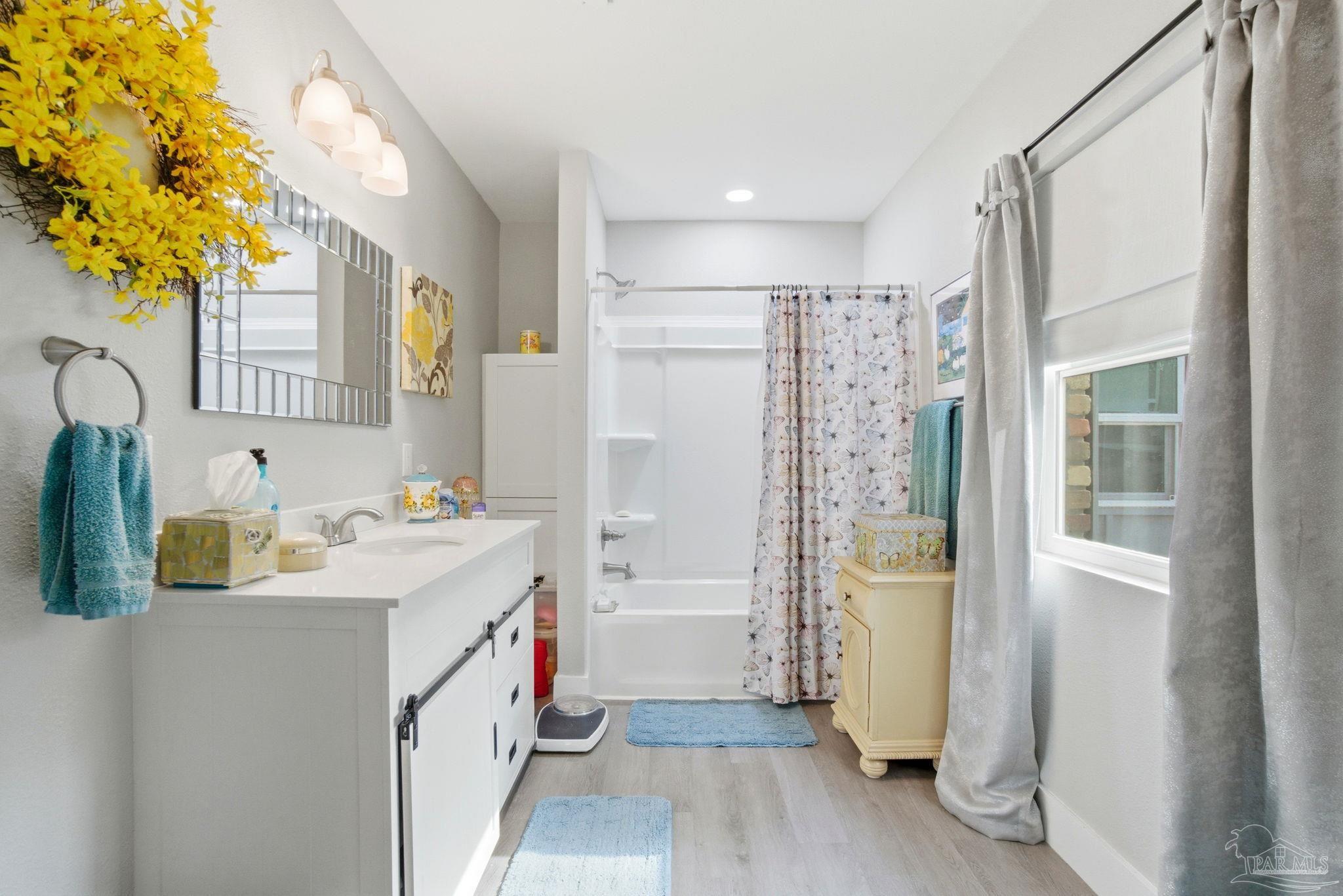 148 San Carlos Road Cantonment, FL 32533 - Photo 24 of 38 a bathroom with a sink a mirror and a shower