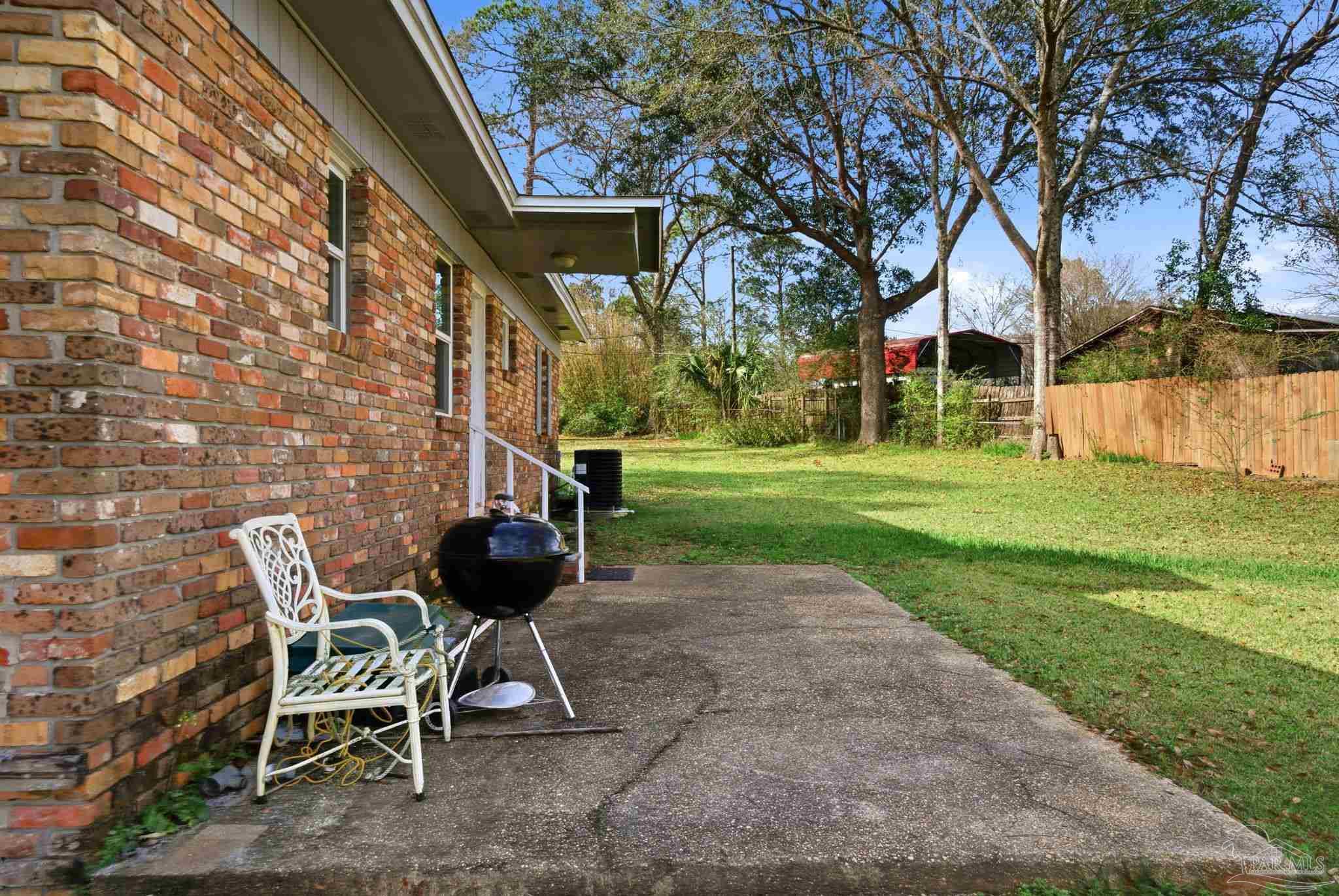 148 San Carlos Road Cantonment, FL 32533 - Photo 28 of 38 a view of a patio with a table and chairs