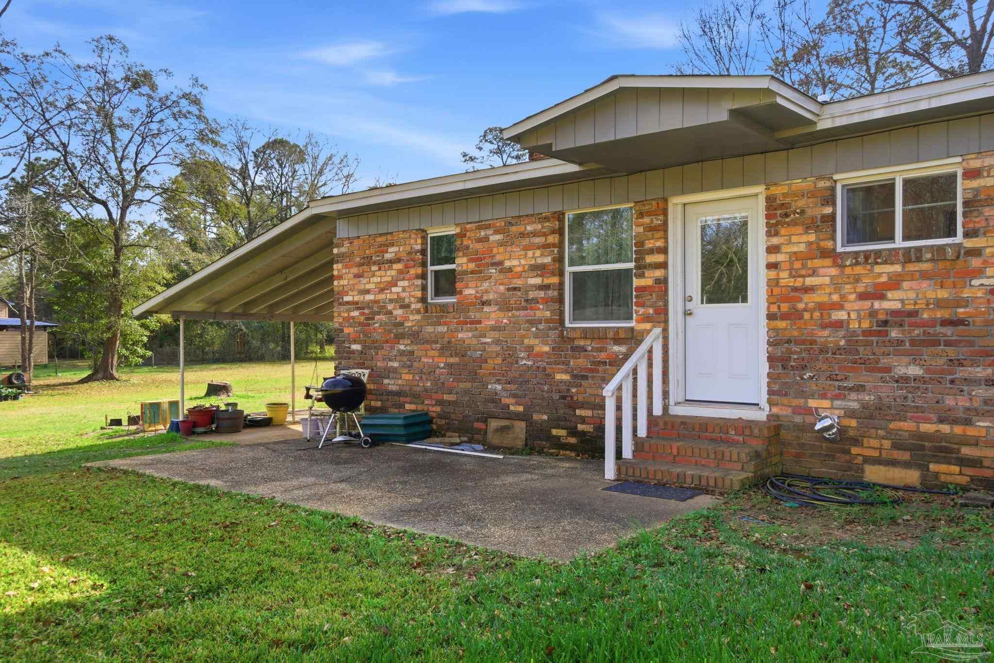 148 San Carlos Road Cantonment, FL 32533 - Photo 29 of 38 a front view of a house with a yard