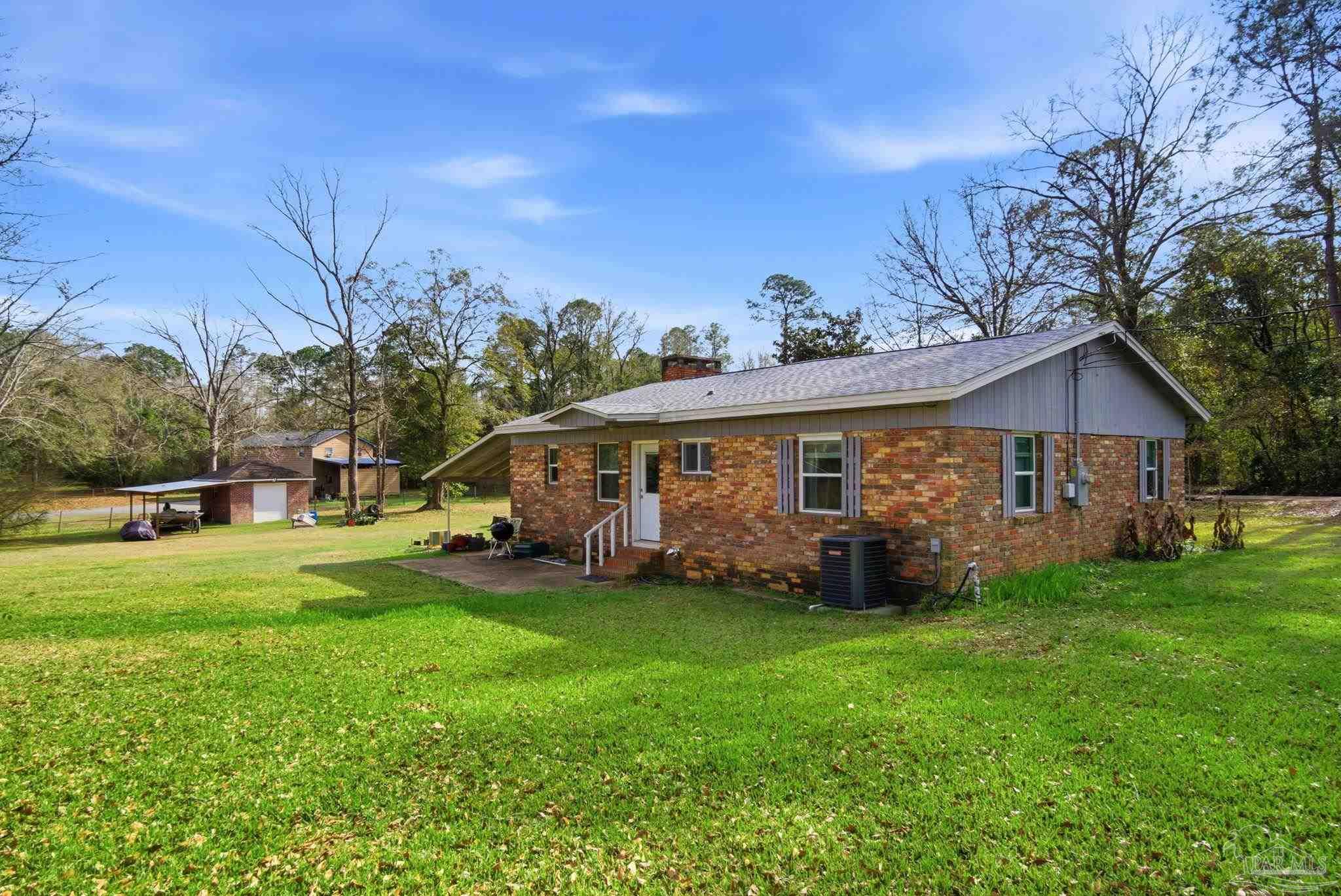 148 San Carlos Road Cantonment, FL 32533 - Photo 30 of 38 a front view of a house with garden