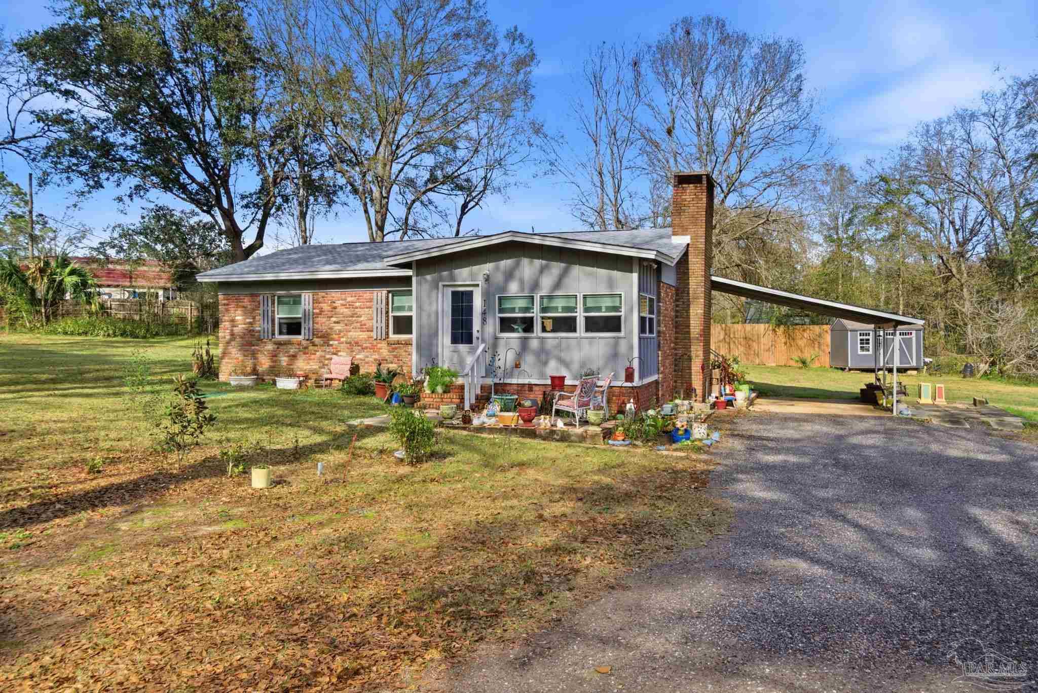 148 San Carlos Road Cantonment, FL 32533 - Photo 3 of 38 a view of a house with backyard and garden