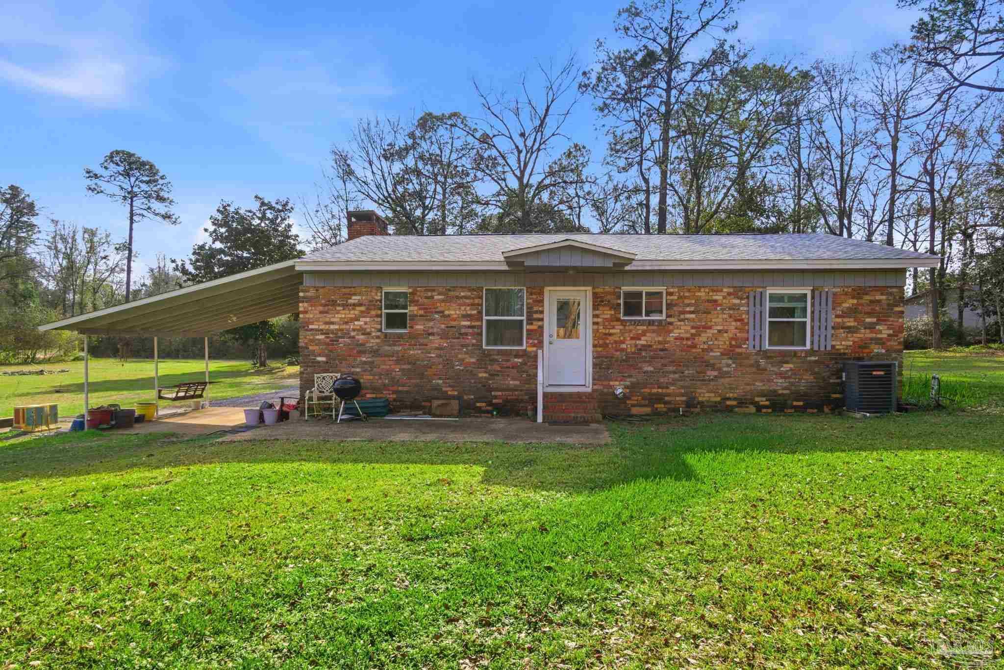 148 San Carlos Road Cantonment, FL 32533 - Photo 31 of 38 a view of a house with a back yard