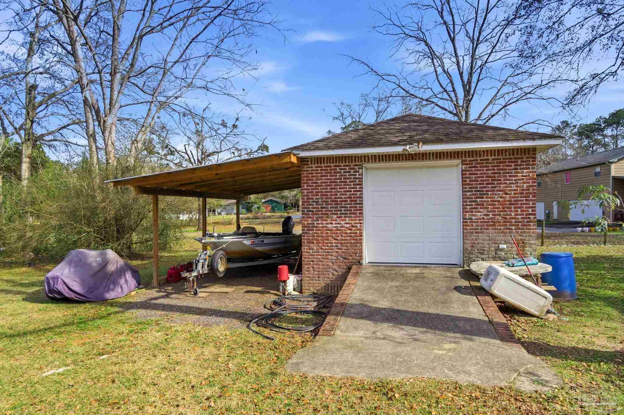 148 San Carlos Road Cantonment, FL 32533 - Photo 35 of 38 a view of a patio with a table and chairs under an umbrella