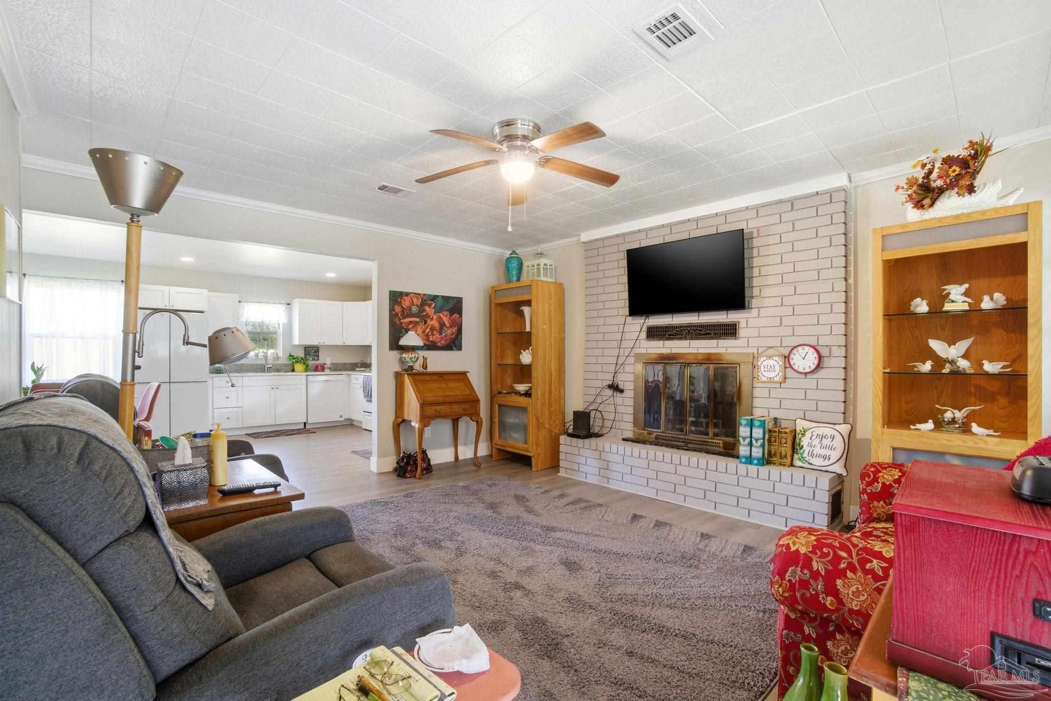 148 San Carlos Road Cantonment, FL 32533 - Photo 8 of 38 a living room with furniture and a flat screen tv