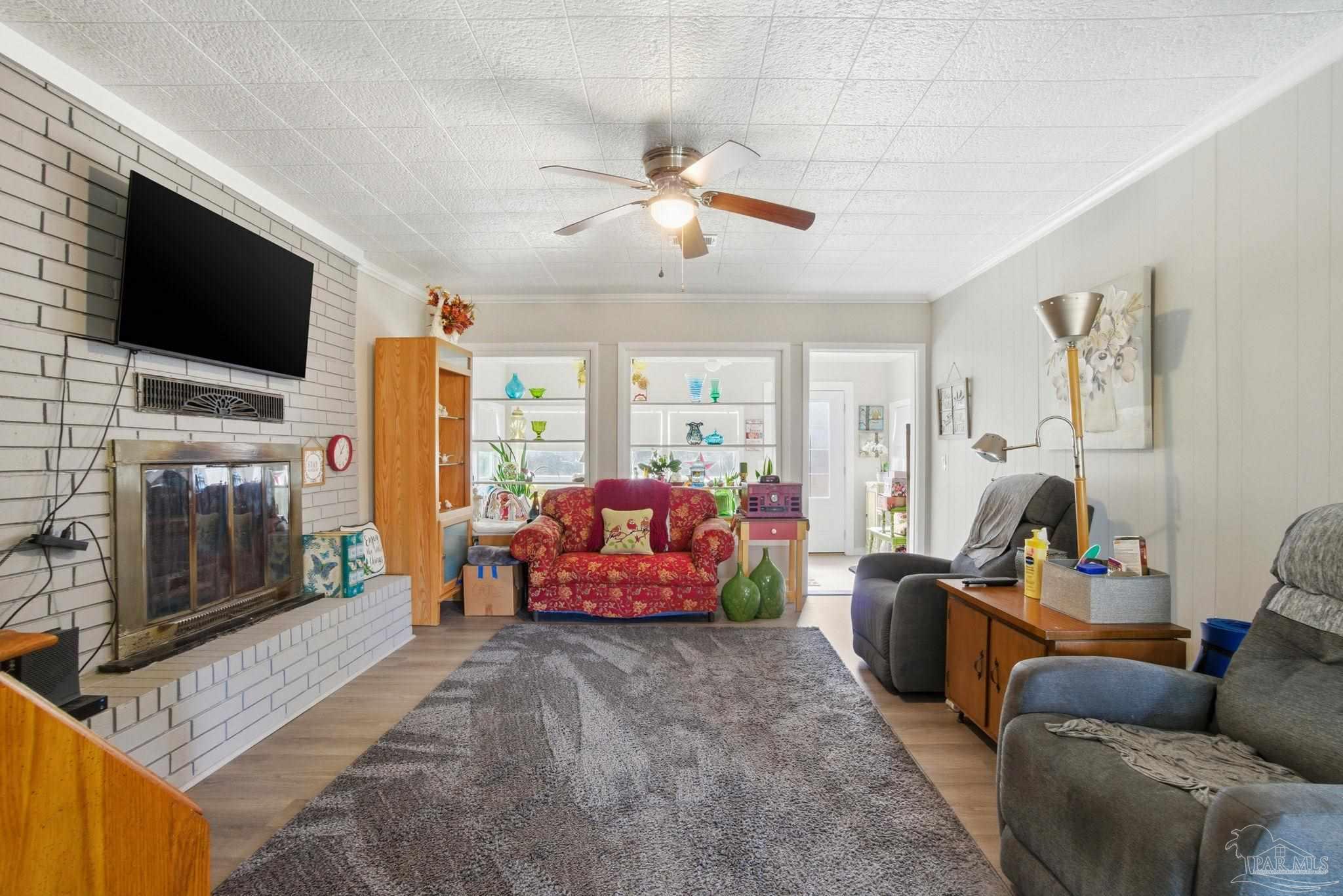 148 San Carlos Road Cantonment, FL 32533 - Photo 10 of 38 a living room with furniture and a flat screen tv